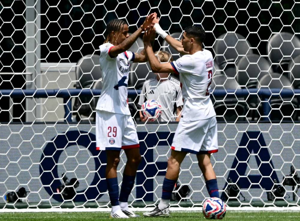 Paris Saint-Germain's Moroccan defender #02 Achraf Hakimi (R) celebrates scoring his team's second goal with Paris Saint-Germain's French forward #29 Bradley Barcola during the FIFA Club World Cup 2025 Group B football match between US Seattle Sounders and France's Paris Saint-Germain at the Lumen Field stadium in Seattle on June 23, 2025. (Photo by Pablo PORCIUNCULA / AFP)