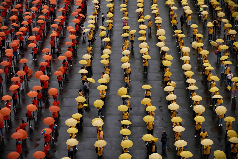 This aerial view shows people taking part in the formation of the world's biggest LGBT pride flag at Zocalo Square in Mexico City, Mexico, on June 22, 2025. (Photo by Rodrigo Oropeza / AFP)