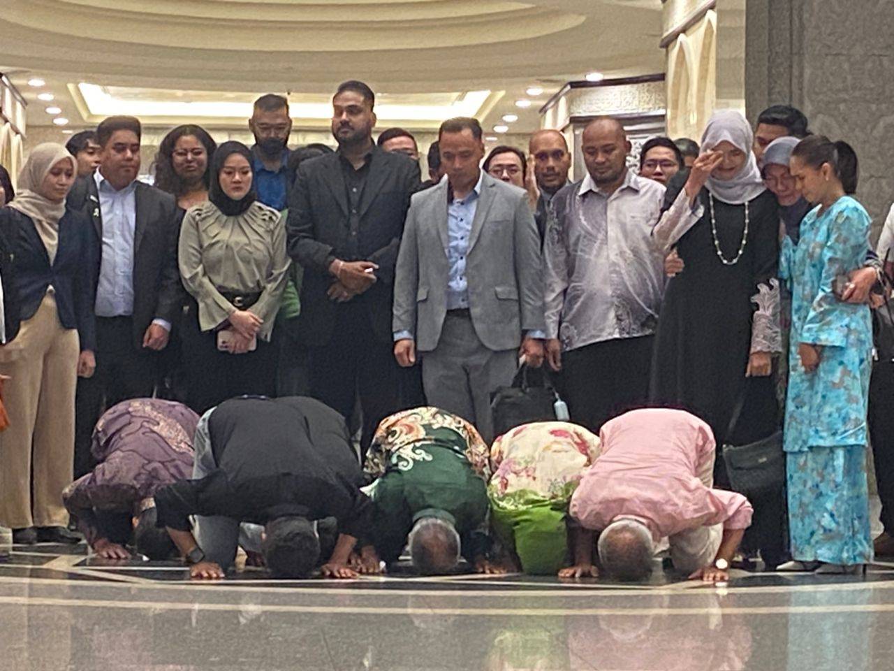 Syed Saddiq Syed Abdul Rahman and his family performed a sujud syukur (prostration of gratitude) at the Court of Appeal here today, immediately after he was acquitted of four charges related to the misappropriation of Angkatan Bersatu Anak Muda (Armada) funds.