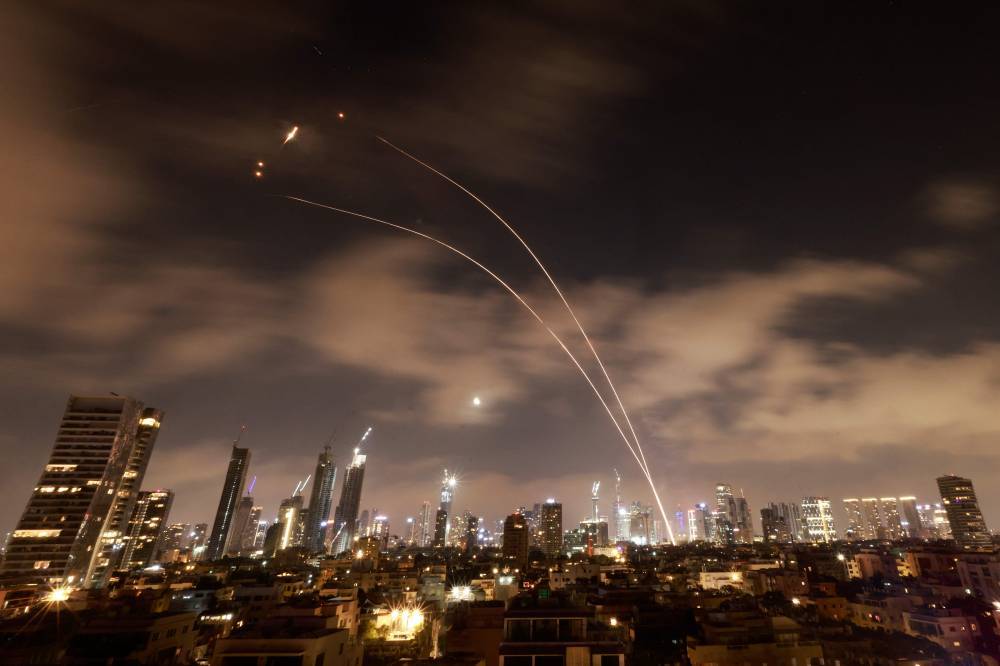 Israeli air defence systems are activated to intercept Iranian missiles over the Israeli city of Tel Aviv early on June 18. Photo by Menahem Kahana/AFP FILE PIX