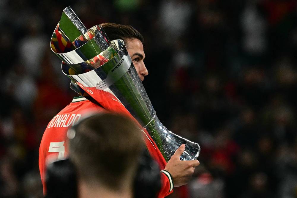 Portugal's forward #07 Cristiano Ronaldo carries the trophy after winning the UEFA Nations League final football match between Portugal and Spain in Munich, southern Germany on June 8, 2025. - (Photo by TOBIAS SCHWARZ / AFP)