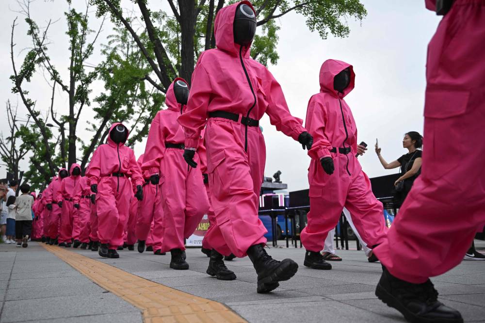 Pink Guards of Squid Game perform during a parade event for Netflix's South Korean TV series "Squid Game Season 3" at Gwanghwamun Square in Seoul on June 28. Photo by Jung Yeon-je/AFP