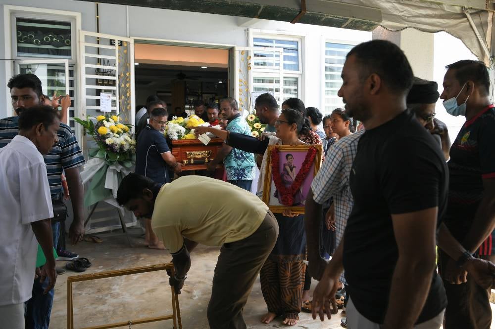 The mother of the late V. Vennpani, K. Nalini, 39, performs a religious ritual during the final rites ceremony at their home in Sungai Petani Heights, today. - Photo by Bernama