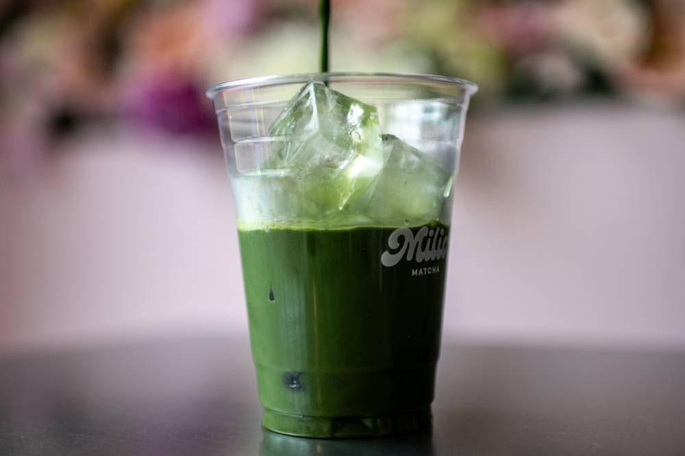 This picture taken on May 31, 2025 shows a staff member of Milia Matcha preparing a matcha drink in Tokyo. (Photo by Philip FONG/AFP)