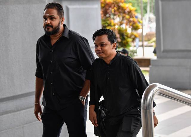 Muda secretary-general Amir Hariri Abd Hadi (left) at the Kuala Lumpur Courts Complex. - BERNAMA FILE PIX