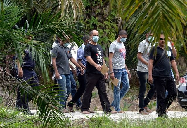 The accused in the murder case of the late DPP Datuk Anthony Kevin Morais was brought to the location where the victim's car was found, near Kampung Sungai Samak, Hutan Melintang on Nov 16, 2016. - BERNAMA FILE PIX