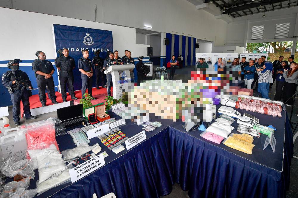 Police have successfully bust an illegal drug laboratory used to produce drugs-laced vape liquids, seizing an estimated RM21.92 million worth of drugs and assets in two separate raids on luxury condominium units in Ampang, Selangor. Photo by Bernama