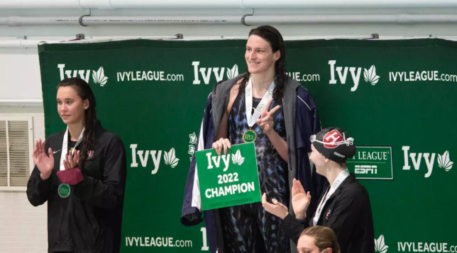 Former University of Pennsylvania transgender swimmer Lia Thomas (center) smiles after winning a race in 2022. - Photo by Kathryn Riley/GETTY IMAGES NORTH AMERICA/AFP