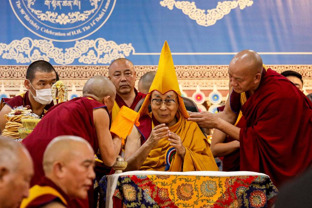 Tibetan spiritual leader the Dalai Lama (C) attends a Long Life Prayer offering ceremony at the Main Tibetan Temple in McLeod Ganj, near Dharamsala on June 30, 2025. Exiled Tibetan spiritual leader, the Dalai Lama, gave on June 30, the strongest indication yet that the 600-year-old institution would continue after his death, at prayer celebrations for his 90th birthday. The leader, who turns 90 on July 6, is according to Tibetans the 14th reincarnation of the Dalai Lama. (Photo by Sanjay BAID / AFP)