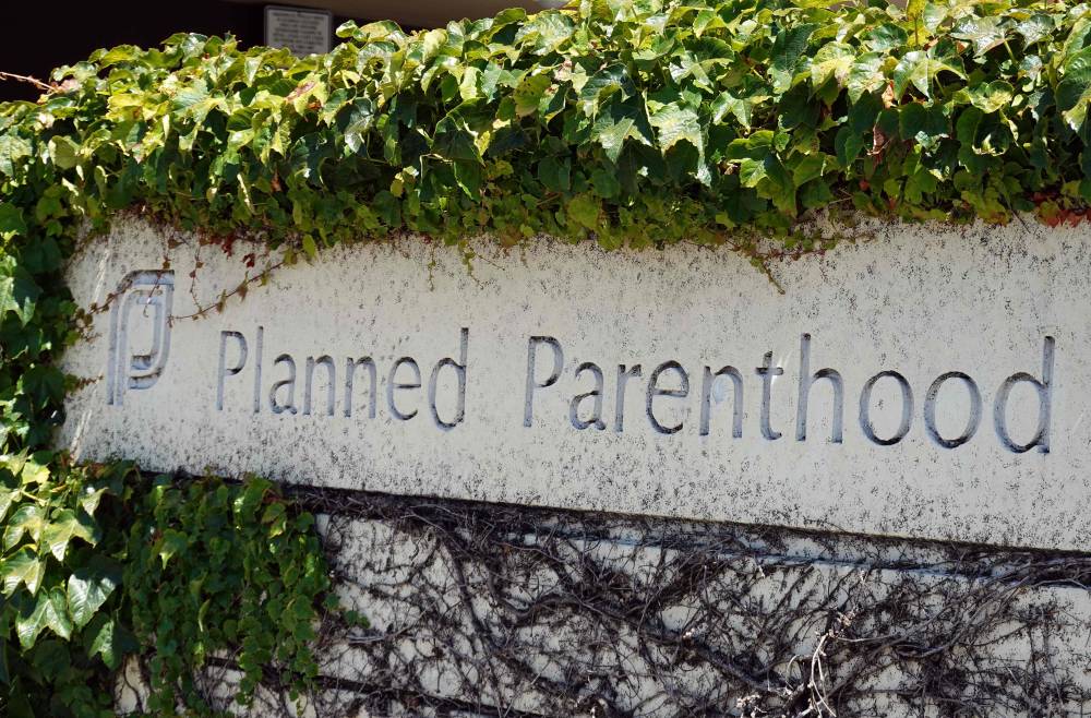 A sign is posted in front of a Planned Parenthood health center on June 26, 2025 in San Rafael, California. A Supreme Court ruling will allow states to cut Medicaid funds to reproductive health provider Planned Parenthood, which will disqualify Medicaid patients from obtaining health care services from Planned Parenthood providers if the funding has been cut by the state.(Photo by JUSTIN SULLIVAN / GETTY IMAGES NORTH AMERICA / Getty Images via AFP)
