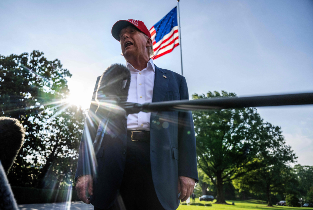 US President Donald Trump talks to members of the press as he departs from the South Lawn of the White House in Washington, DC on July 1, 2025. (Photo by Jim WATSON / AFP)