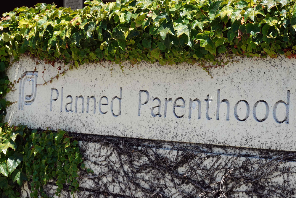 A sign is posted in front of a Planned Parenthood health center on June 26, 2025 in San Rafael, California. A Supreme Court ruling will allow states to cut Medicaid funds to reproductive health provider Planned Parenthood, which will disqualify Medicaid patients from obtaining health care services from Planned Parenthood providers if the funding has been cut by the state.(Photo by JUSTIN SULLIVAN / GETTY IMAGES NORTH AMERICA / Getty Images via AFP)