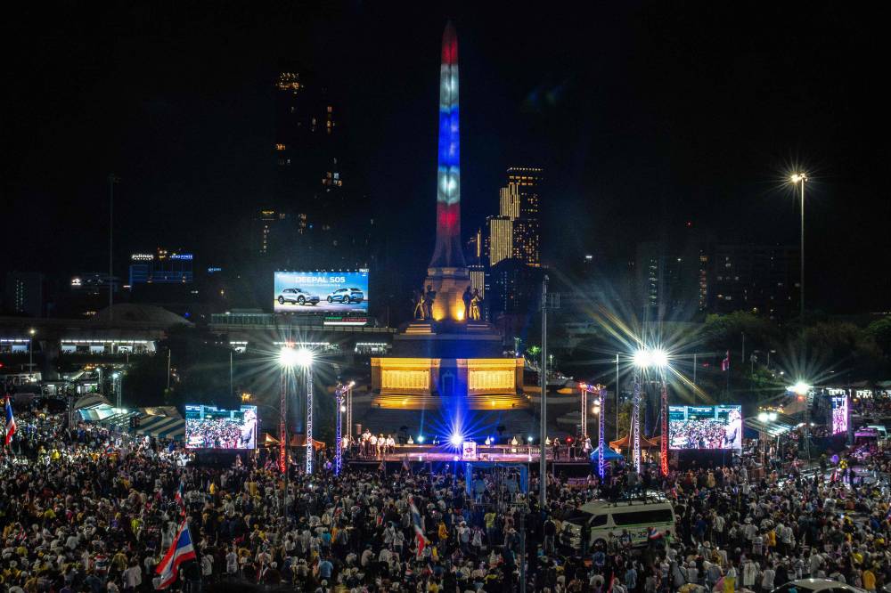 Anti-government protesters rally to demand the removal of Thailand's Prime Minister Paetongtarn Shinawatra from office at Victory Monument in Bangkok on June 28, 2025. Thousands of anti-government protesters rallied in the Thai capital Bangkok on June 28, demanding Prime Minister Shinawatra resign after a leaked diplomatic phone call stirred public anger. (Photo by Chanakarn Laosarakham / AFP)