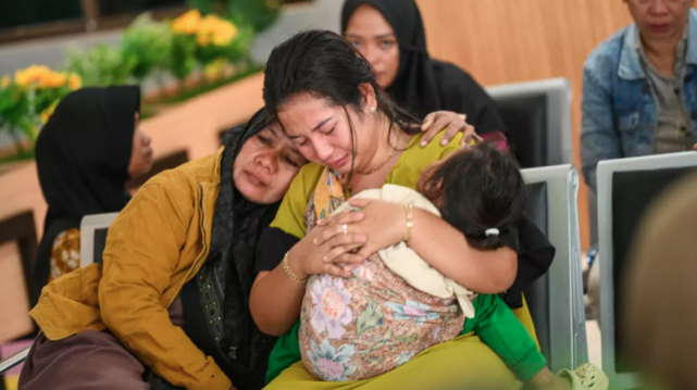 Family members wait at Ketapang Port in East Java for updates on the search for missing people after a ferry sank on its way to the popular Indonesian resort island of Bali. - Photo via STR/AFP 