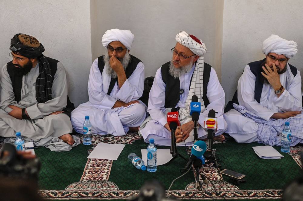 Deputy Prime Minister of the Taliban Abdul Salam Hanafi (2R) speaks with media during his visit to the Islam Qala border crossing between Afghanistan and Iran on June 28, 2025. (Photo by Wakil KOHSAR / AFP)
