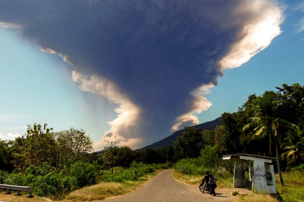 Mount Lewotobi Laki-laki erupts, as seen from Nangahale village in Sikka, East Nusa Tenggara on July 7, 2025. - (Photo by ARNOLD WELIANTO / AFP)