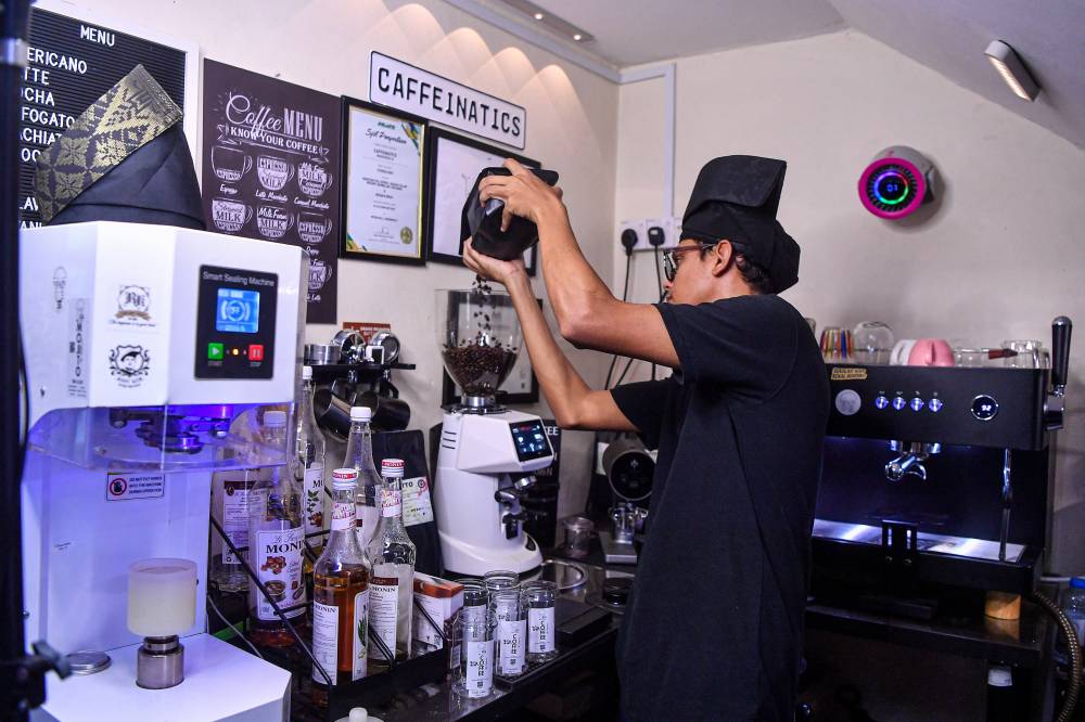 Caffeinatics entrepreneur, Mohammad Amin Hashim, prepares coffee before bottling it for distribution to several vendor locations around Senawang, Bandar Seri Jempol, Kajang, and Bangi, at his residence in Senawang recently. - Bernama photo