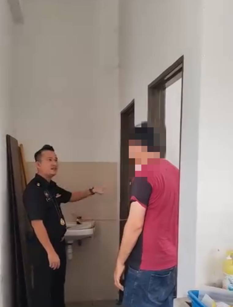 A screenshot shows the Pakistani national opening the toilet door, which had been tied shut with a rope from the outside.