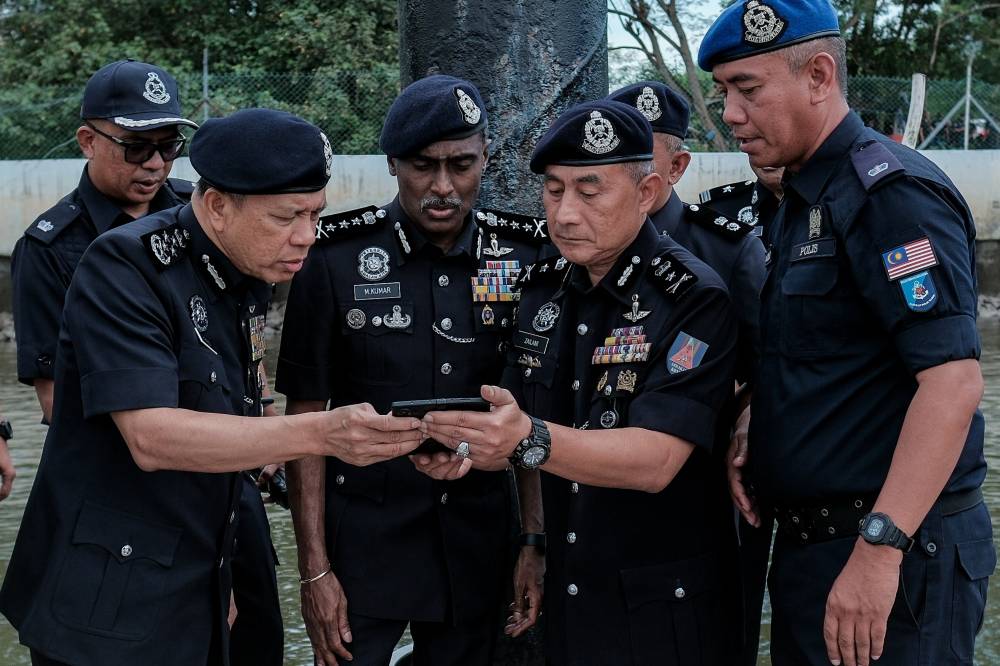 Inspector-General of Police, Datuk Seri Mohd Khalid Ismail (left), along with the Johor Police Chief, Datuk M. Kumar (centre), inspect the site of the police helicopter involved in an accident during training for the Malaysia-Indonesia-Thailand-Singapore 2025 Nuclear Security Detection Multilateral Training Program (MITSATOM 2025) at the Malaysian Maritime Enforcement Agency (APMM) jetty in Johor today. - Bernama photo