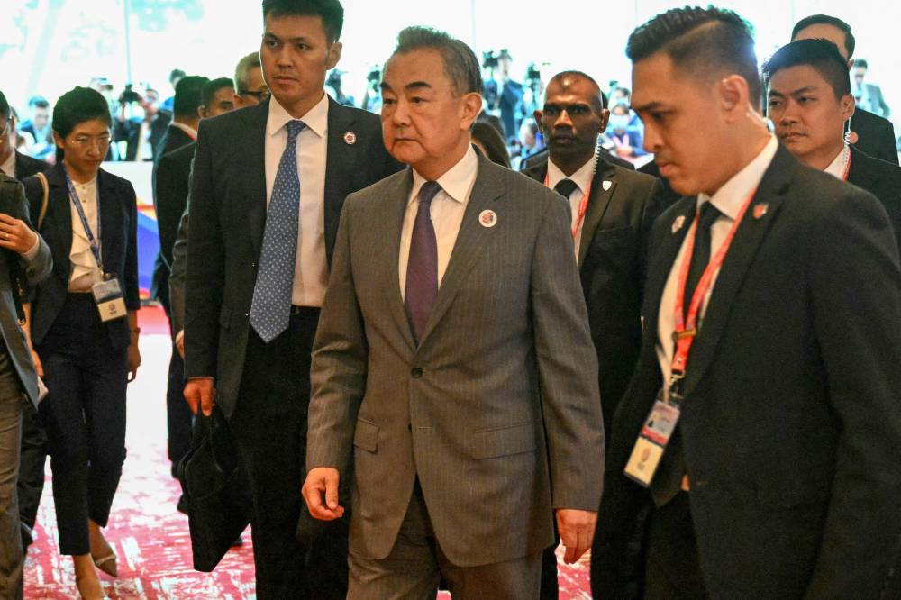 China's Foreign Minister Wang Yi (centre) walks on his way to a meeting with US Secretary of State Marco Rubio during the 58th Asean Foreign Ministers' meeting and related meetings at the Convention Centre in Kuala Lumpur. Photo by Mandel Ngan /POOL/AFP