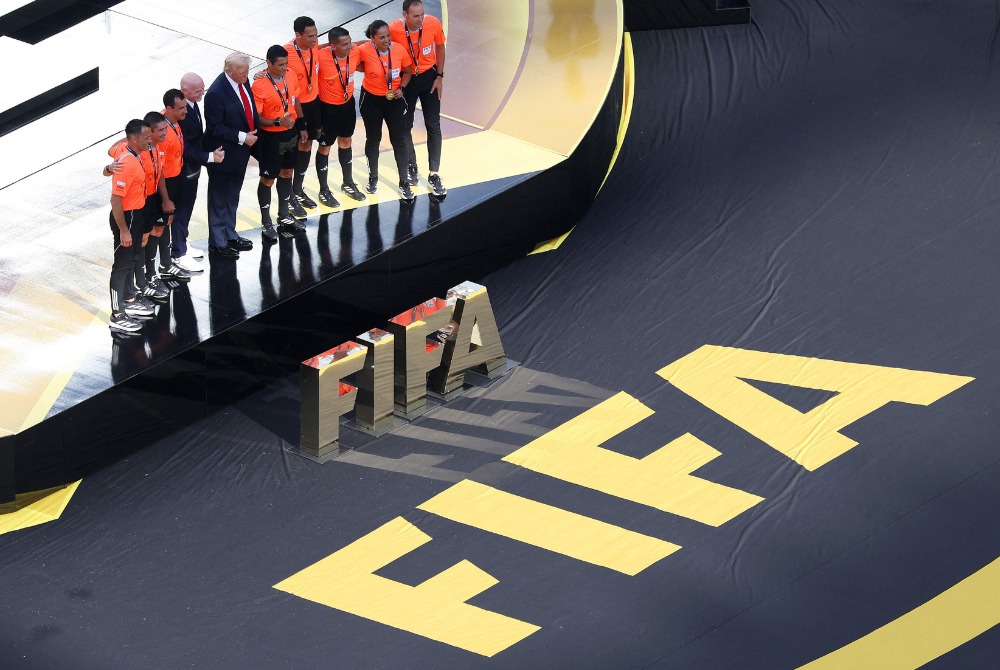 Gianni Infantino, President of FIFA, and US President Donald Trump pose for a photo with video match officials and referees after Chelsea FC won during the FIFA Club World Cup 2025 Final match between Chelsea FC and Paris Saint-Germain at MetLife Stadium on July 13, 2025 in East Rutherford, New Jersey. Jared C. Tilton/Getty Images/AFP (Photo by Jared C. Tilton / GETTY IMAGES NORTH AMERICA / Getty Images via AFP)
