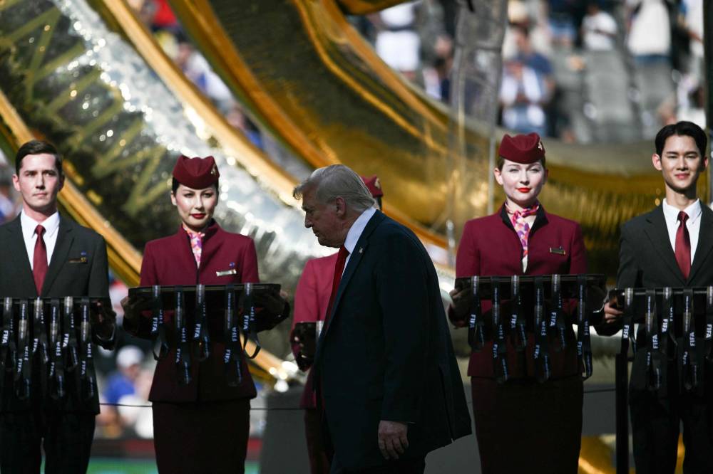 US President Donald Trump walks to the podium for the award ceremony for the FIFA Club World Cup 2025 Champions, following the final football match between England's Chelsea and France's Paris Saint-Germain at the MetLife Stadium in East Rutherford, New Jersey on July 13, 2025. (Photo by Brendan SMIALOWSKI / AFP)