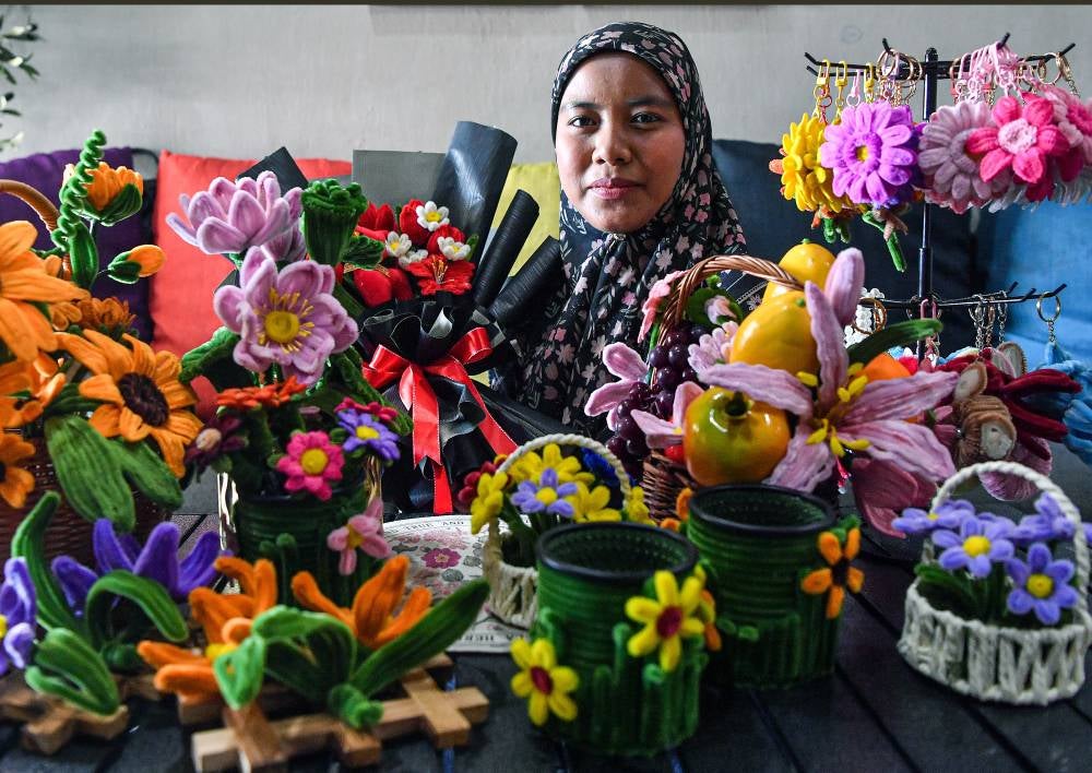 Siti Amirah Pilus, 36, said she first ventured into floral arrangement in 2014 by taking orders for wedding gifts before switching entirely to crafting with velvet wire over the past three years. Photo by Bernama