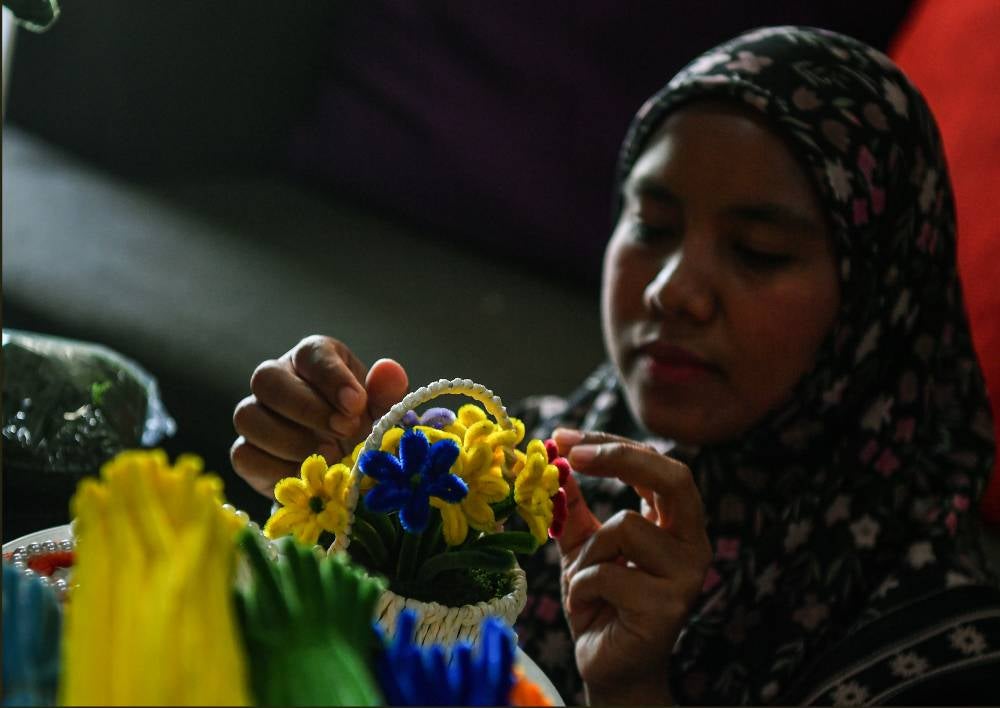Siti Amirah Pilus, 36, said she first ventured into floral arrangement in 2014 by taking orders for wedding gifts before switching entirely to crafting with velvet wire over the past three years. Photo by Bernama