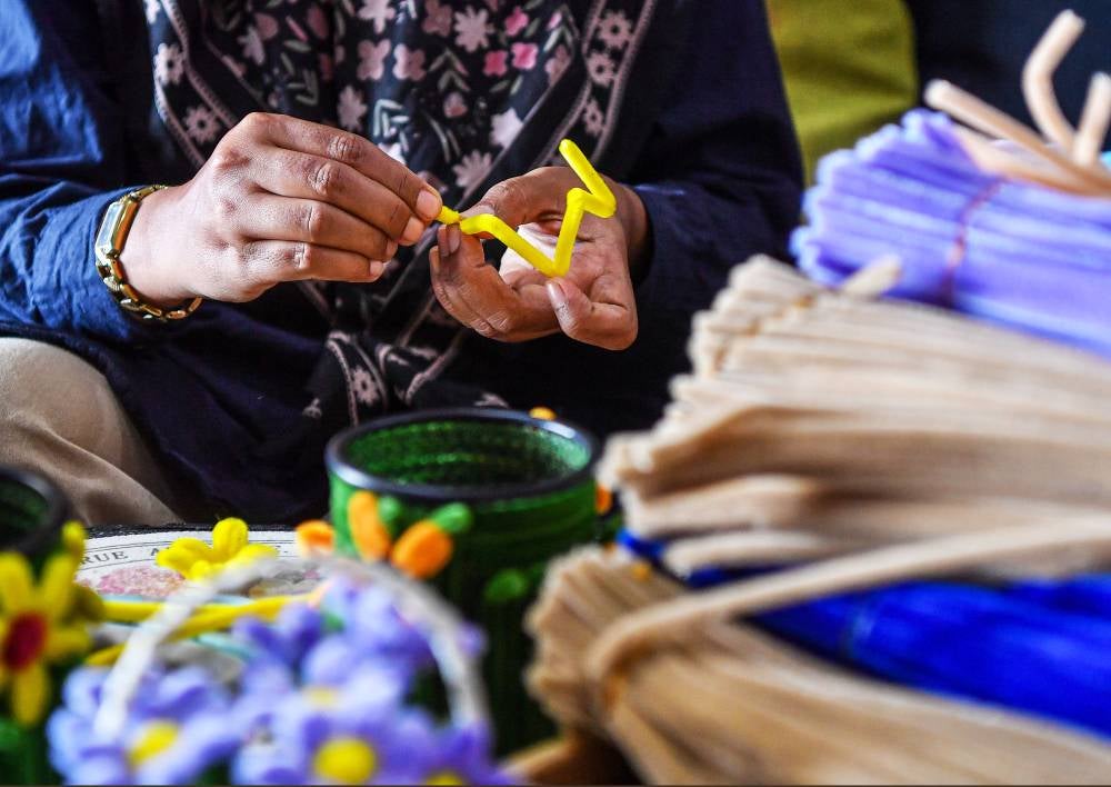 Siti Amirah Pilus, 36, said she first ventured into floral arrangement in 2014 by taking orders for wedding gifts before switching entirely to crafting with velvet wire over the past three years. Photo by Bernama
