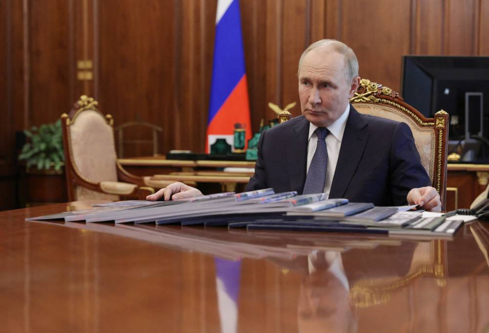 In this pool photograph distributed by the Russian state agency Sputnik, Russia's President Vladimir Putin meets with Belgorod Region Governor in Moscow on July 11, 2025. (Photo by Mikhail METZEL / POOL / AFP)