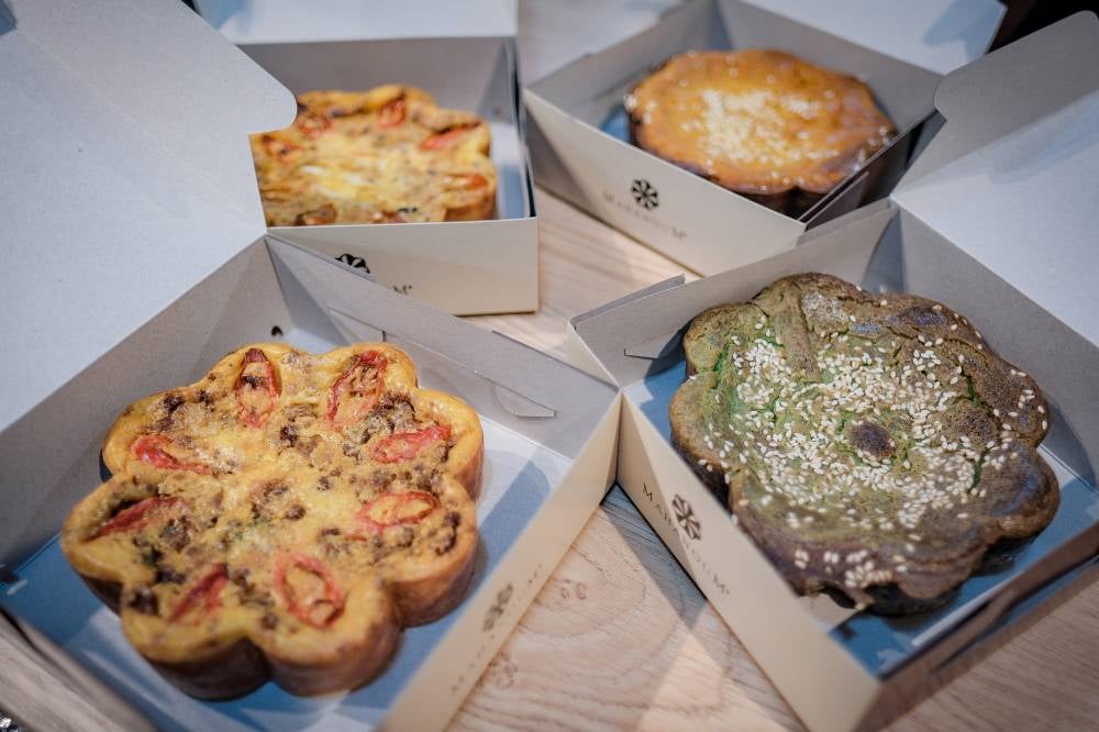 Instead of the usual sweet and fragrant pandan kuih bakar, husband-and-wife entrepreneurs in Johor Bahru are making savoury versions of the traditional delicacy, experimenting with new flavours including durian, beef and sardines. Photo by Bernama