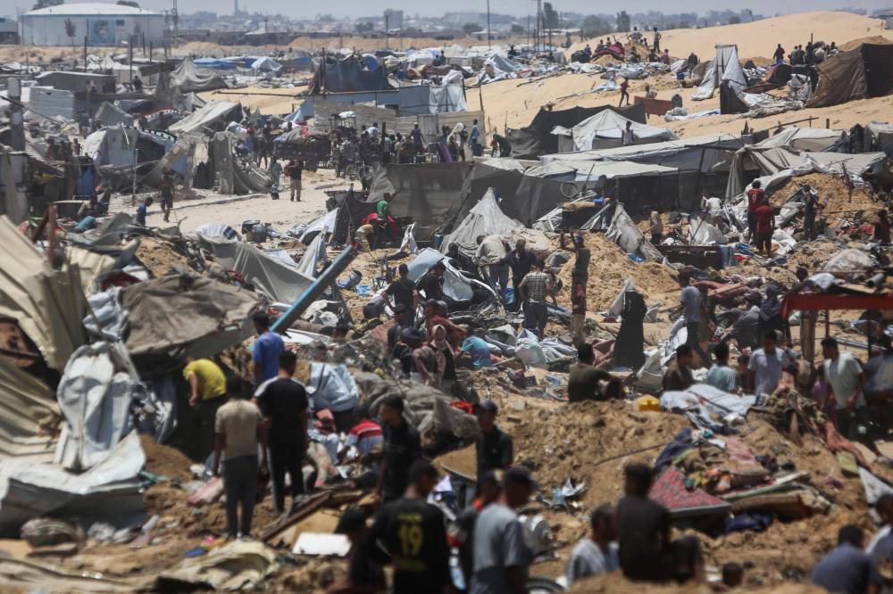 Palestinians inspect the destruction at a makeshift displacement camp following a reported incursion a day earlier by Israeli tanks in the area in Khan Yunis in the northern Gaza strip on July 11, 2025. - (Photo by AFP)