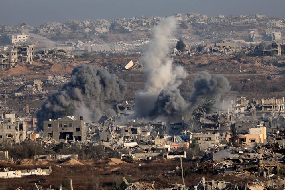This picture taken from a position at Israel's border with the Gaza Strip shows smoke billowing during an Israeli strike on the besieged Palestinian territory on July 17, 2025. (Photo by Jack GUEZ / AFP)