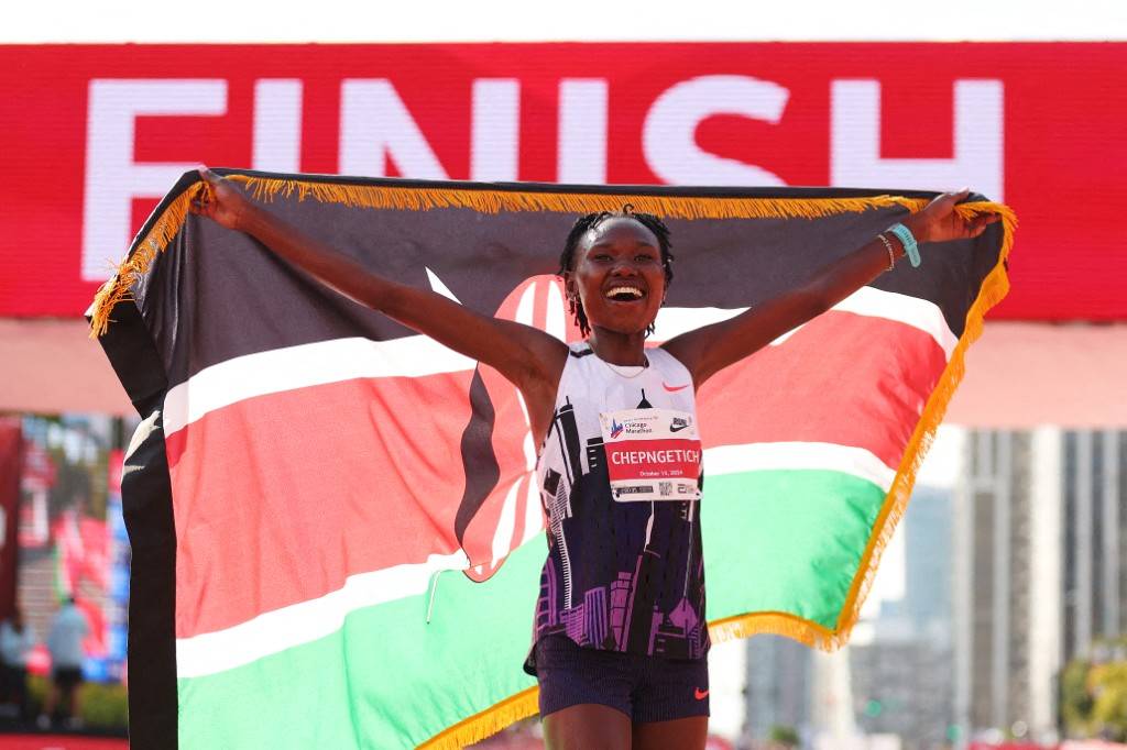 Ruth Chepngetich of Kenya celebrates after crossing the finish line to win the 2024 Chicago Marathon professional women's division and setting a new world record with a time of 2:09:56 at Grant Park on October 13, 2024 in Chicago, Illinois. (Photo by Michael Reaves / GETTY IMAGES NORTH AMERICA / Getty Images via AFP)