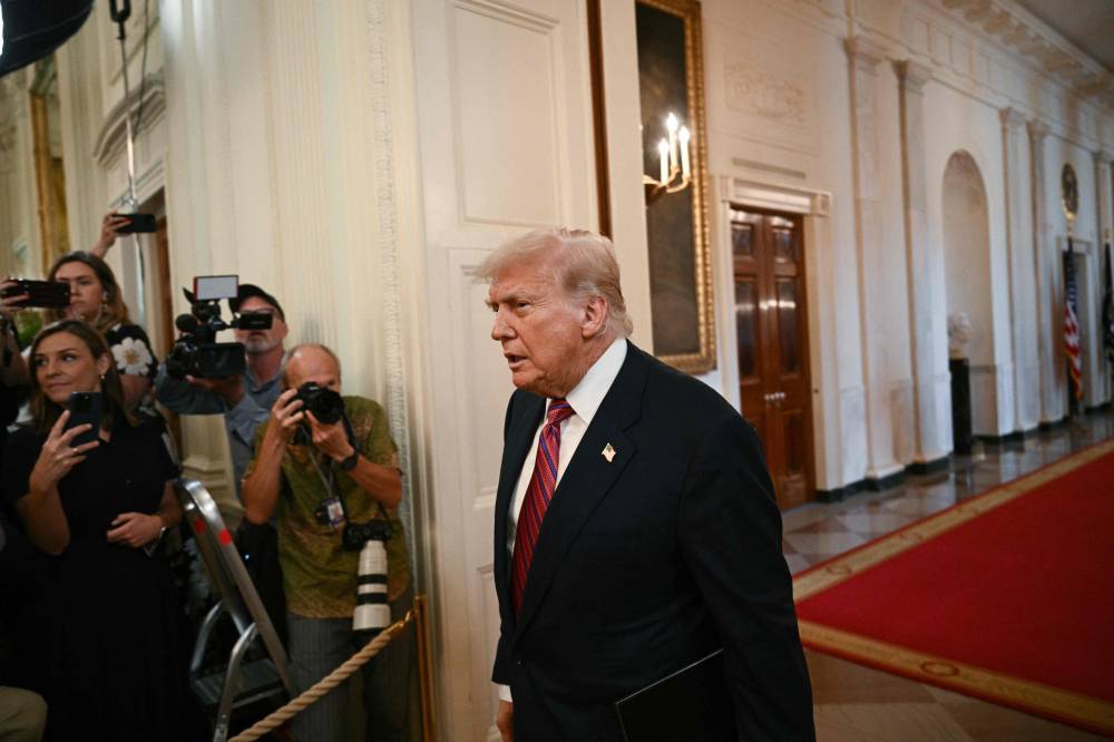 US President Donald Trump arrives to sign the GENIUS Act (Guiding and Establishing National Innovation for US Stablecoins Act), which codifies the use of stablecoins -- cryptocurrencies pegged to stable assets like the US dollar or US bonds -- in the East Room of the White House in Washington, DC, on July 18, 2025. - (Photo by BRENDAN SMIALOWSKI / AFP)
