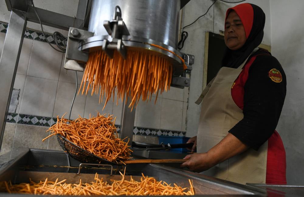 Idris Alias, 67, and his wife, Fatimah Ishak, 63, from Guar Perahu, here, started their small home-based business in 1984 after she inherited a muruku recipe from her mother-in-law. Photo by Bernama