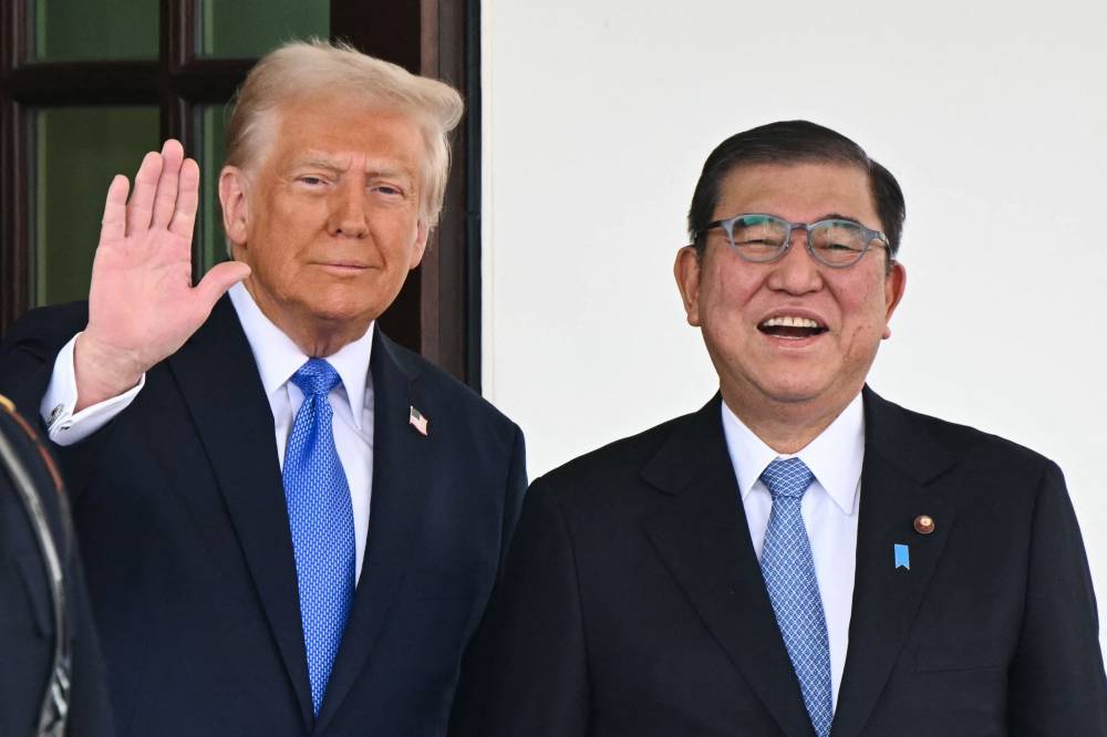 US President Donald Trump waves as he greets Japanese Prime Minister Shigeru Ishiba upon arrival outside the West Wing of the White House in Washington, DC, on Feb 7, 2025. Photo by Mandel Ngan/AFP