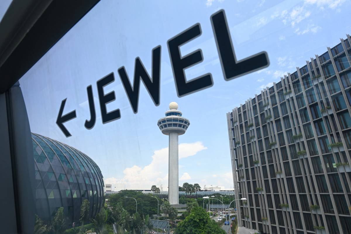 A sign shows the direction to the Jewel complex at Singapore Changi Airport in Singapore on April 10, 2025. (Photo by Roslan RAHMAN / AFP)