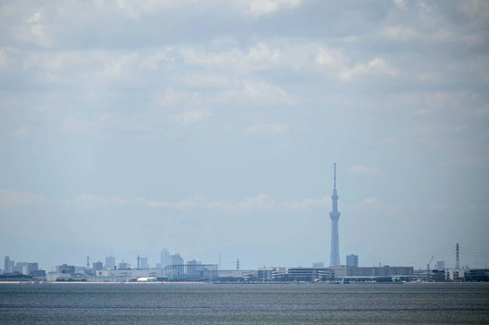 The Tokyo Skytree (R) is pictured from across Tokyo Bay after much of coastal Japan went on tsunami alert following a 8.7 magnitude quake in the sea off eastern Russia, in Chiba City, Chiba prefecture on July 30, 2025. Tsunamis hit parts of Russia's Far East and Japan on July 30 after a huge magnitude 8.8 earthquake, with warnings in place around the Pacific of waves of over three metres (10 feet) in places. - (Photo by PHILIP FONG / AFP)