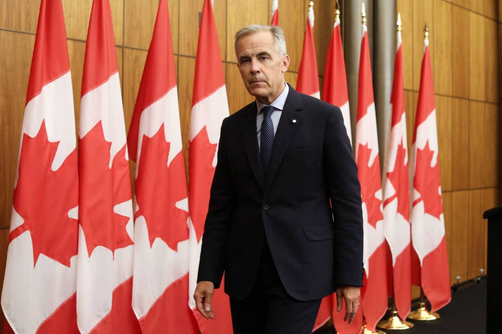 Canadian Prime Minister Mark Carney leaves after speaking during a press conference after a Cabinet meeting to discuss both trade negotiations with the US and the situation in the Middle East, at the National Press Theatre in Ottawa, Ontario, Canada on July 30, 2025. Canada