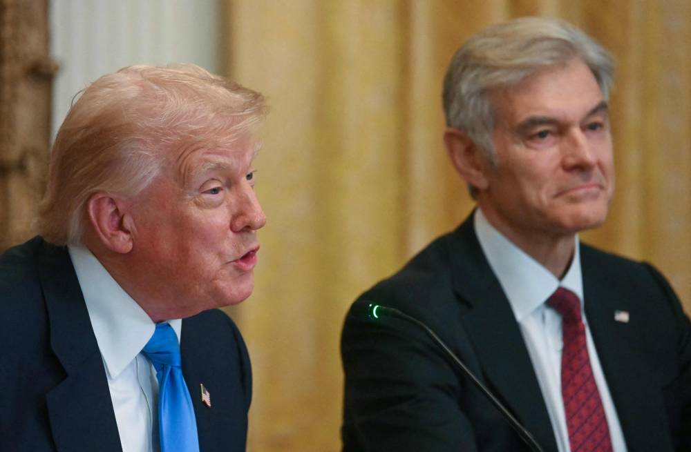 Medicare and Medicaid Administrator Mehmet Oz (right) listens to US President Donald Trump speak at an event on