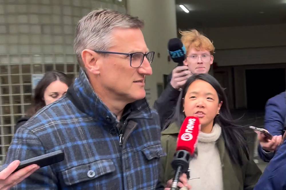 This frame grab taken from AFPTV footage on Aug 4, 2025 shows New Zealand's former deputy police commissioner Jevon McSkimming (front) leaving court after he was charged with possessing child sexual exploitation and bestiality material in Wellington. - (Photo by BEN STRANG / AFPTV / AFP)