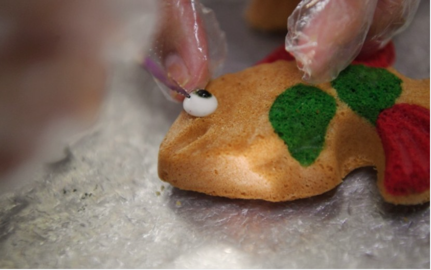 Traditionally shaped like flowers or fish, the bahulu they make come in the shapes of roses, tulips, pineapples and corn, and in attractive colours, in line with modern consumer demand. - Bernama photo