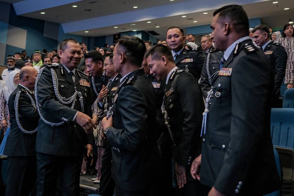 New Johor Police Chief, CP Ab Rahaman Arsad (second from left), greets officers during the Handover of Duties Ceremony for the position of Johor Police Chief at the Johor Police Contingent Headquarters today. - Bernama photo
