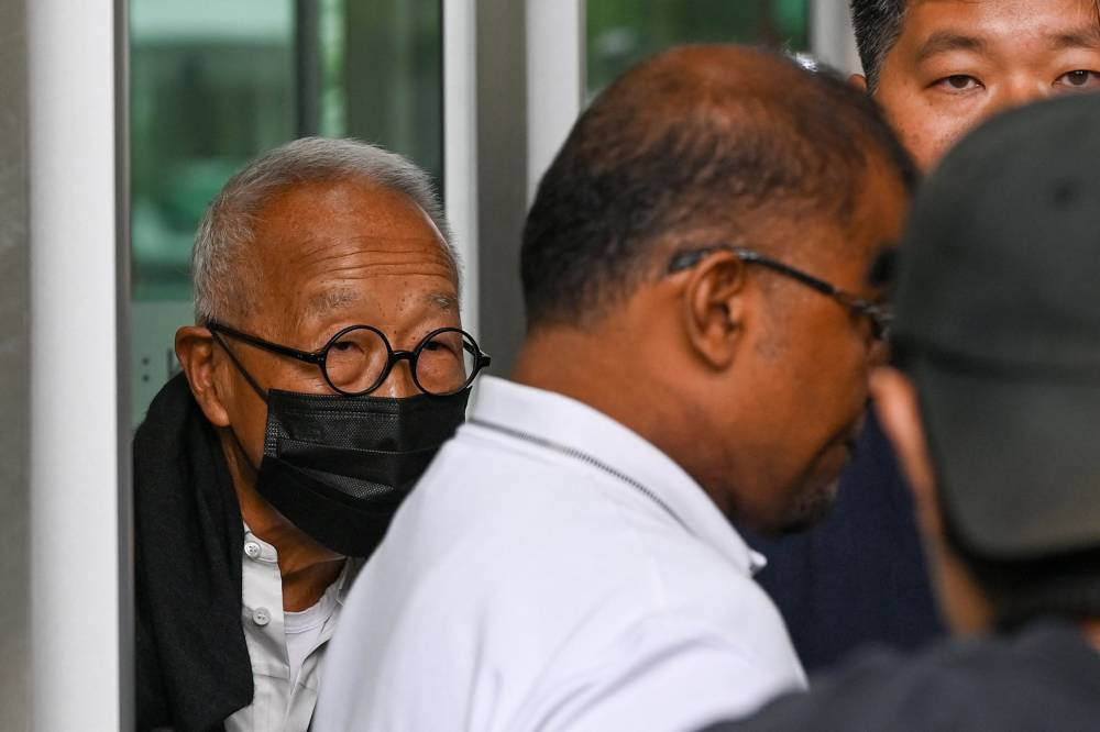 Malaysian hotel tycoon Ong Beng Seng (L) leaves the State Court in Singapore on August 4, 2025. Malaysian hotel tycoon Ong Beng Seng pleaded guilty August 4 to a charge linked to the city-state's former transport minister who was jailed for corruption. (Photo by Roslan RAHMAN / AFP)