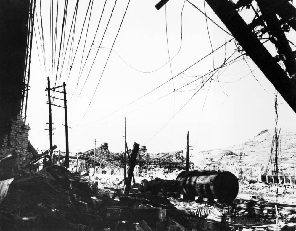 This file photo taken in 1945 next to the Urakami river in Nagasaki shows a wrecked brick wall and a Mitsubishi steel factory after the US bombing of the city. The US nuclear bombing of Hiroshima on August 6, 1945 left around 140,000 people dead. It was followed days later by the bombing of Nagasaki on August 9 that killed around 74,000 people. The twin bombings dealt the final blow to imperial Japan, which surrendered on August 15, 1945, bringing an end to World War II. (Photo by AFP)