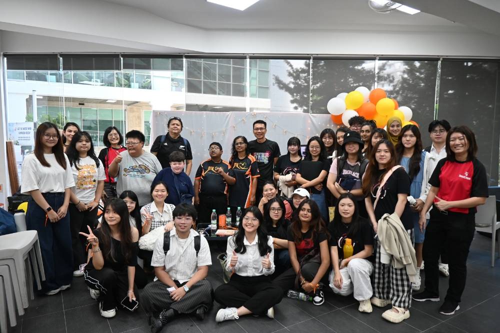 Individuals living with PWS, Mike, Nagheendran and Ken, with their caregivers Azman, Maheswarie and Lantz, together with the participants of PWS Human Library, after the engaging session. 