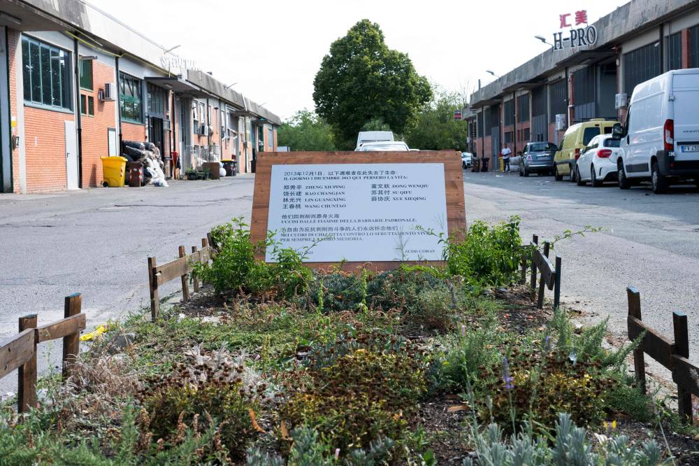 This photograph shows a commemorative plaque at the site where seven Chinese workers died in a fire on December 2013, in the industrial district in Prato, central Italy, on August 1, 2025. Chinese groups in the district thrive on the so-called 