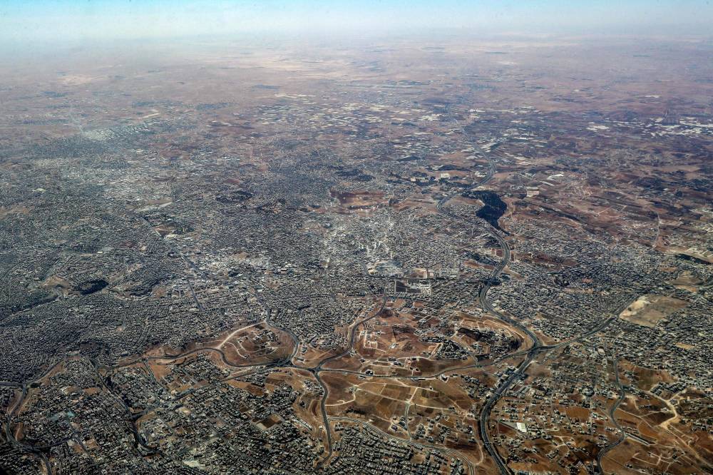 This aerial view shot from a German Air Force (Luftwaffe) military transport aircraft during an airdrop relief mission shows the scene in the Gaza Strip on Aug 5, 2025. Photo by Khalil Mazraawi/AFP
