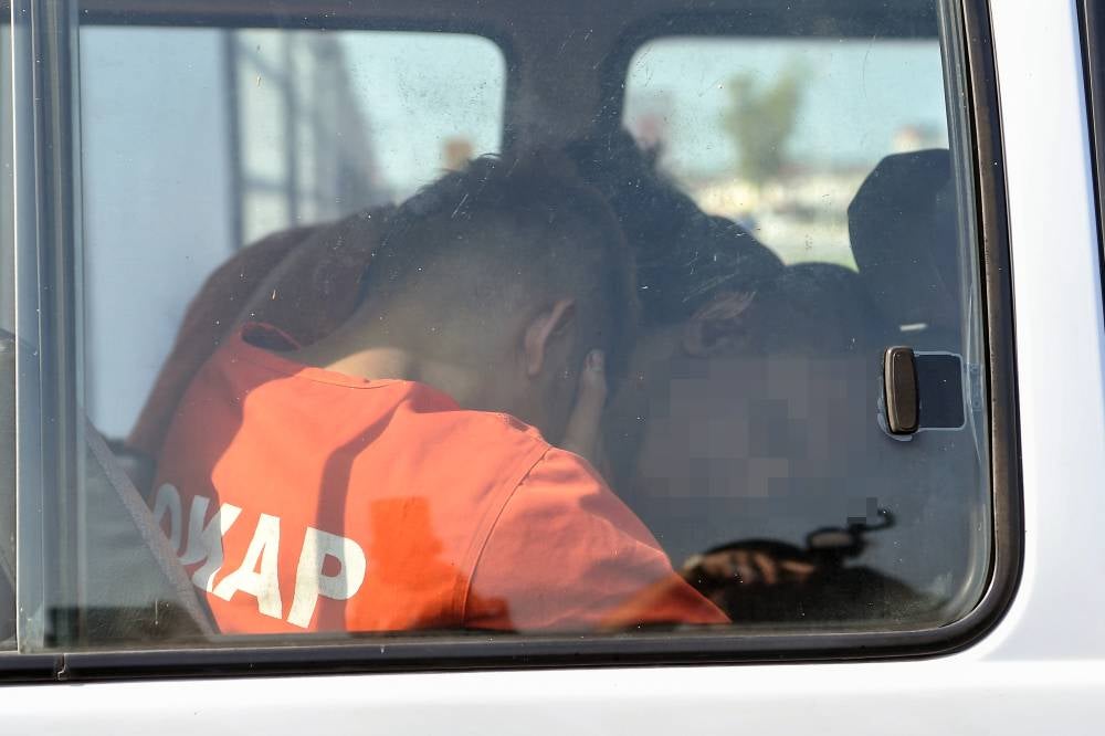 Four suspects involved in a house burglary and the fatal ramming of a police officer were taken to the Alor Setar Court for remand proceedings today. Photo by Bernama